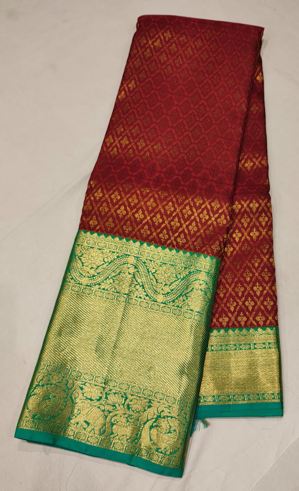 Maroon Kanchee Silk Saree with Emerald Green Zari Border and Rich Temple Weave.
